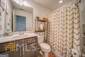 882 Ambient Way Atlanta, GA 30331 - Photo 41 of 61 a bathroom with a granite countertop sink and a mirror