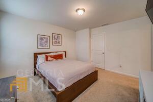 882 Ambient Way Atlanta, GA 30331 - Photo 42 of 61 a bedroom with a bed and painting on the wall
