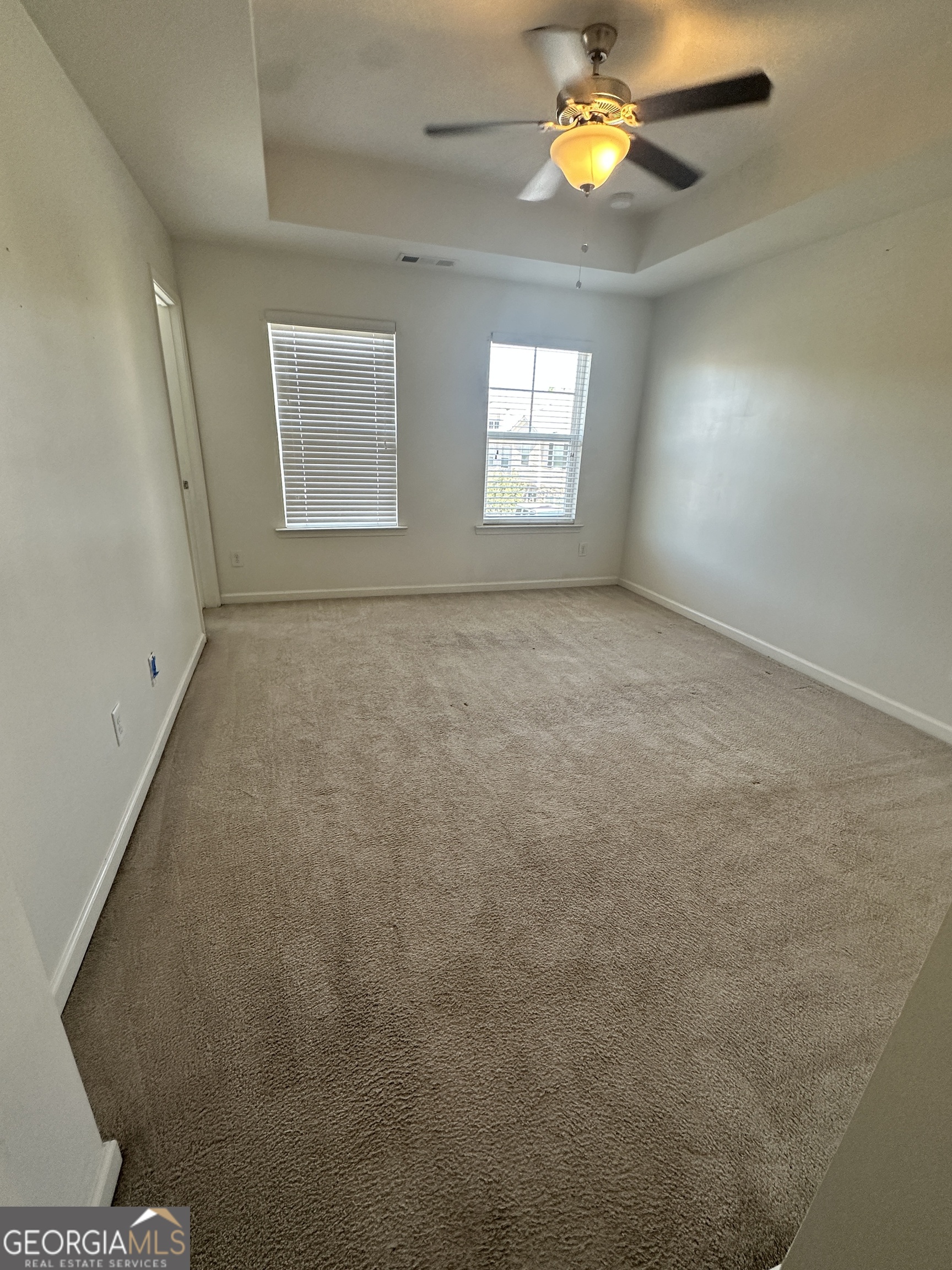 882 Ambient Way Atlanta, GA 30331 - Photo 55 of 61 an empty room with windows and chandelier fan