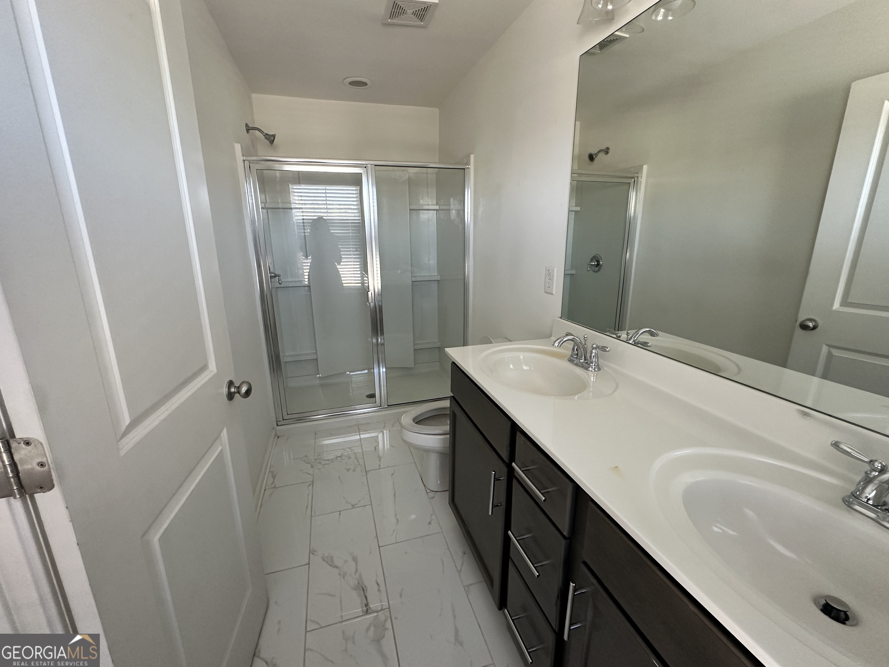 882 Ambient Way Atlanta, GA 30331 - Photo 56 of 61 a bathroom with a sink a toilet and shower
