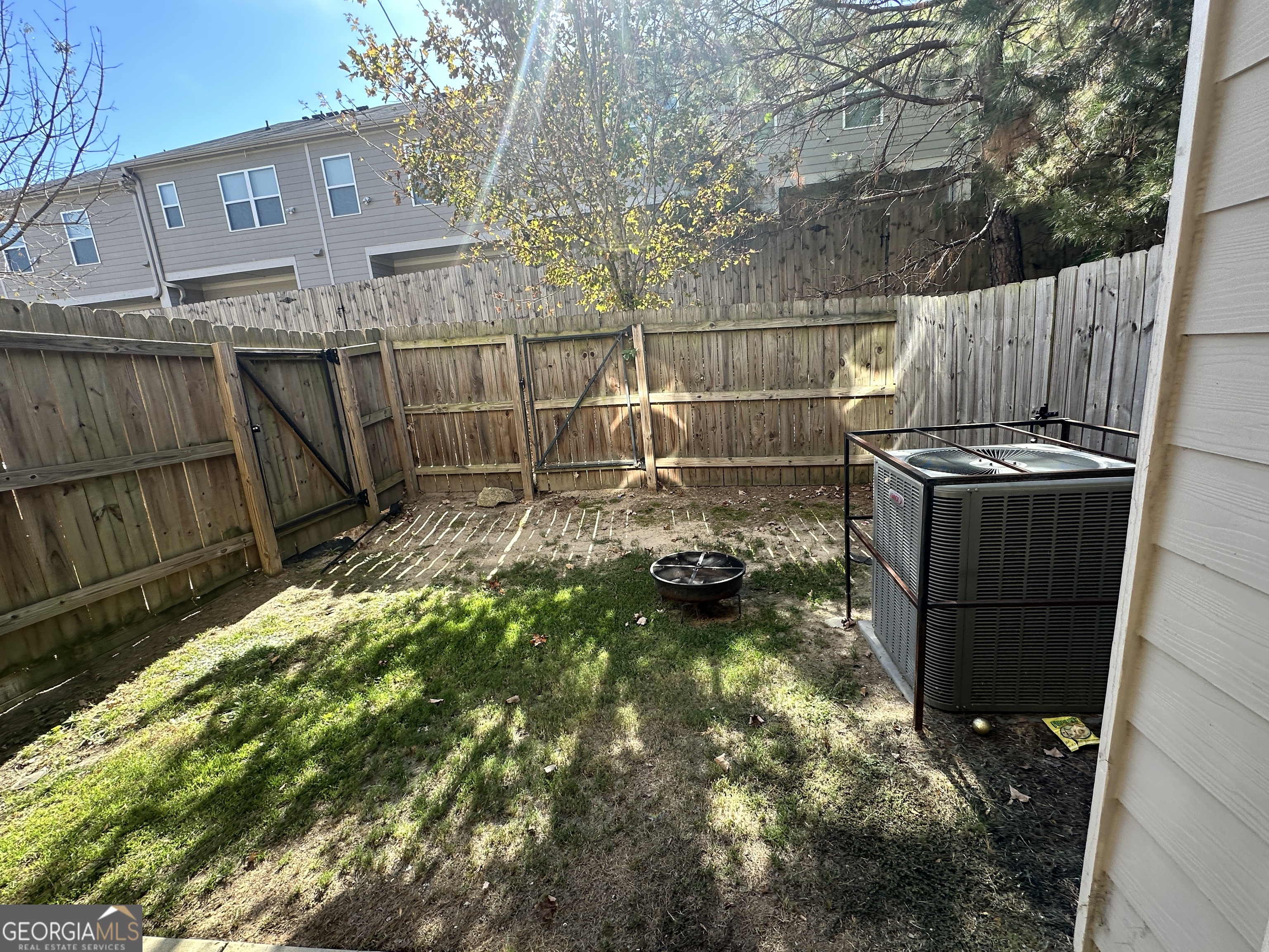 882 Ambient Way Atlanta, GA 30331 - Photo 59 of 61 a backyard of a house with table and chairs
