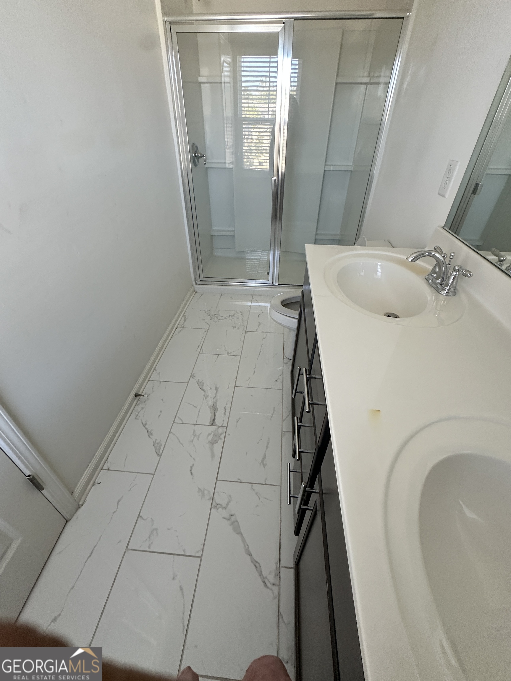 882 Ambient Way Atlanta, GA 30331 - Photo 60 of 61 a bathroom with a sink and glass door shower