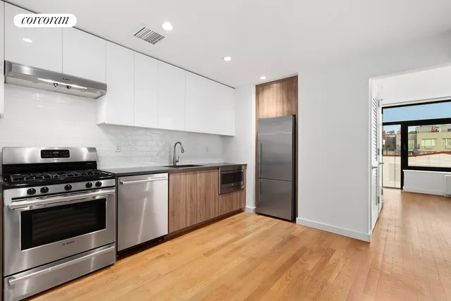 a kitchen with stainless steel appliances granite countertop a stove and a refrigerator