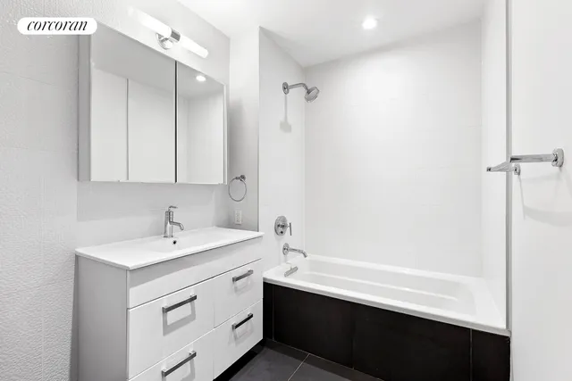 a bathroom with a sink double vanity and a bathtub