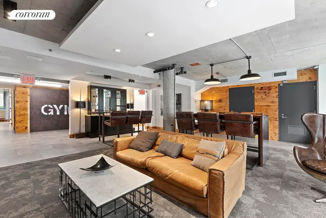 a living room with furniture kitchen view and a table