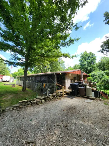 a view of a backyard with chair and tables