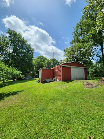 a view of a backyard with large trees