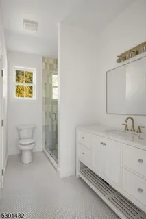 a spacious bathroom with a toilet sink and mirror