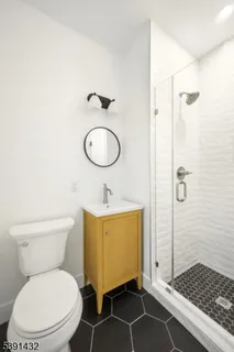 a bathroom with a toilet a sink and a shower