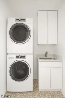 a utility room with sink dryer and washer