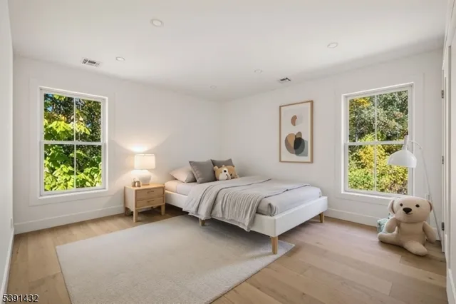 a spacious bedroom with a bed and a window