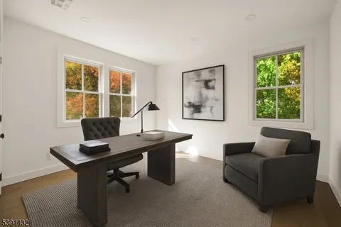 a view of a livingroom with workspace and a couch