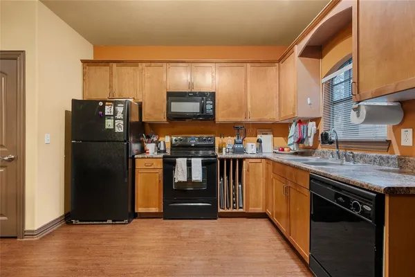 a kitchen with stainless steel appliances granite countertop a refrigerator and a stove top oven