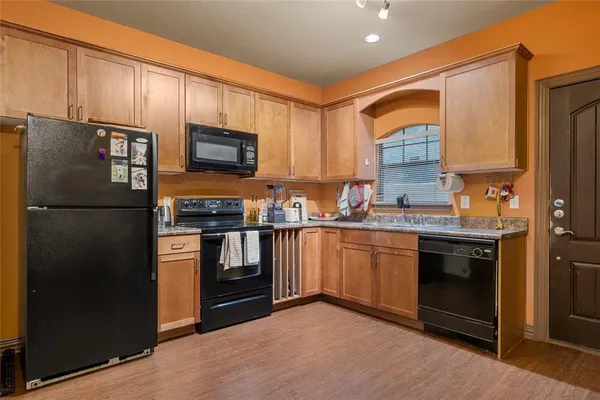 a kitchen with stainless steel appliances granite countertop a refrigerator and a stove top oven