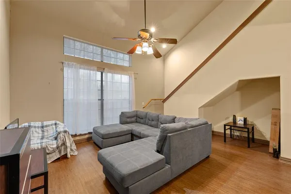 a living room with furniture and a chandelier