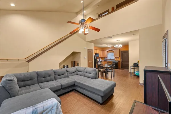a living room with furniture and a dining table with projector