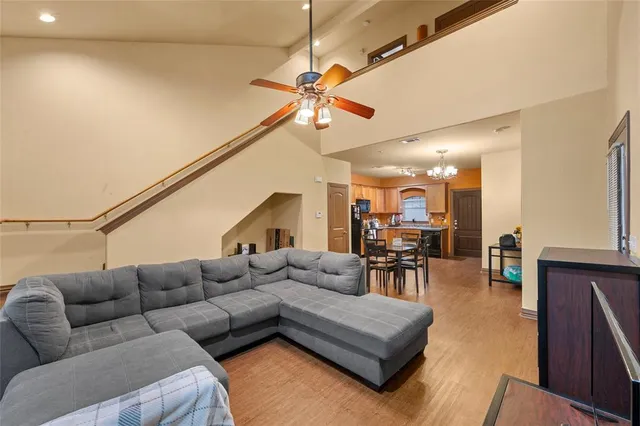 a living room with furniture and a dining table with projector