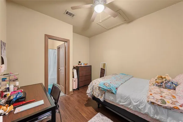 a bedroom with a bed and a desk in it