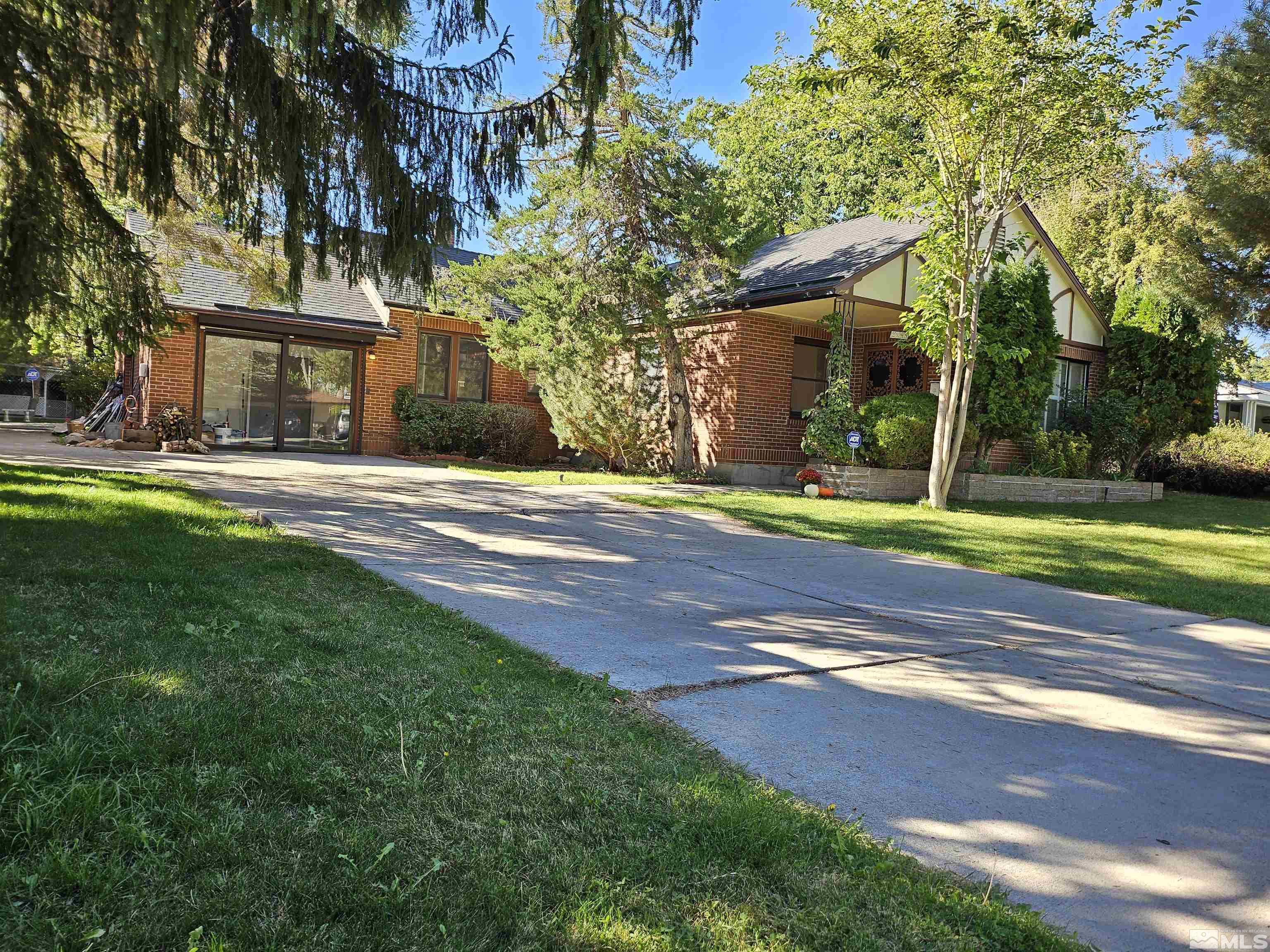 2199 Humboldt Street Reno, NV 89509 - Photo 1 of 35 a view of a house with a yard and large trees