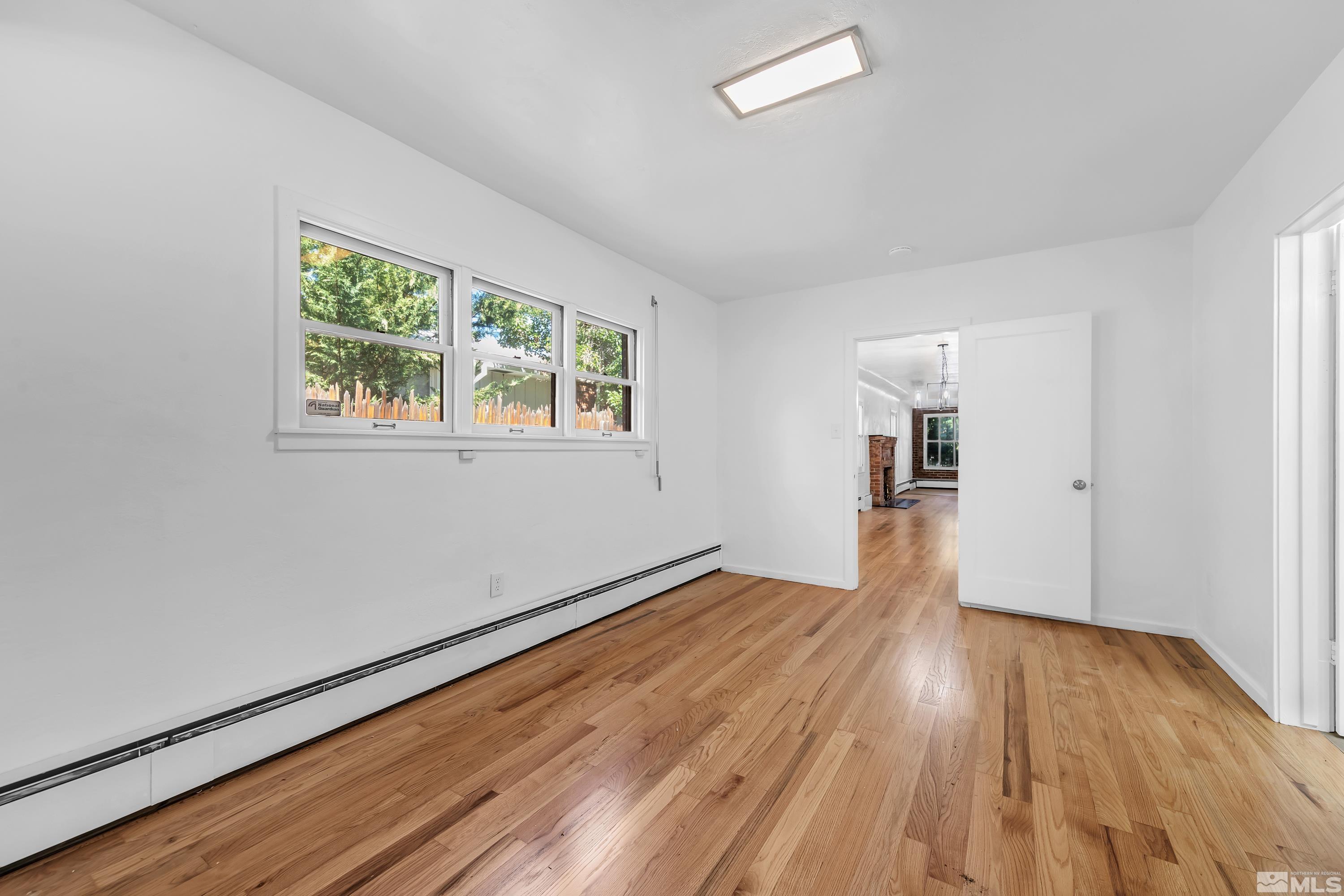 2199 Humboldt Street Reno, NV 89509 - Photo 14 of 35 an empty room with wooden floor and windows