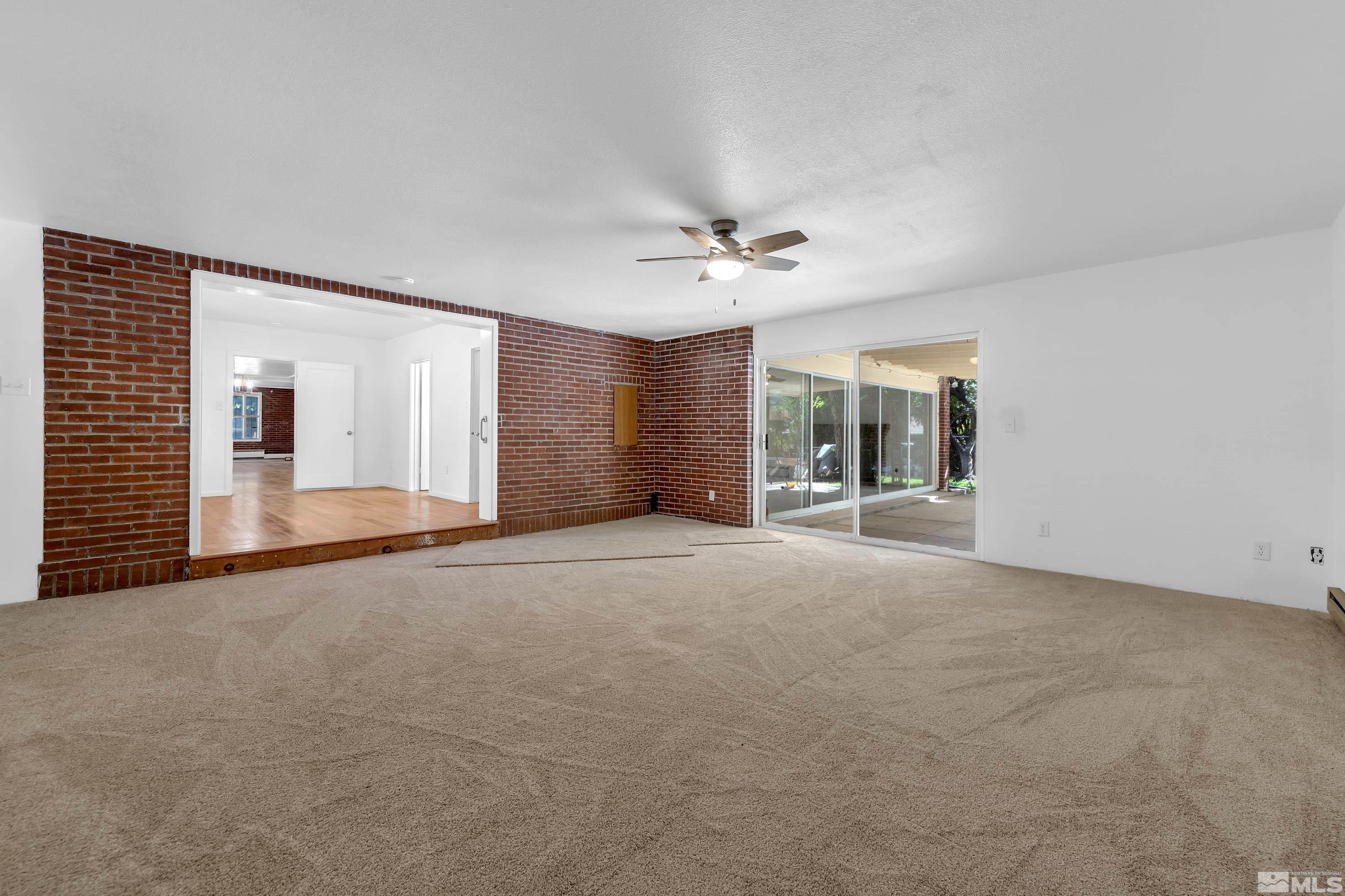 2199 Humboldt Street Reno, NV 89509 - Photo 17 of 35 a view of an empty room with chandelier fan and windows