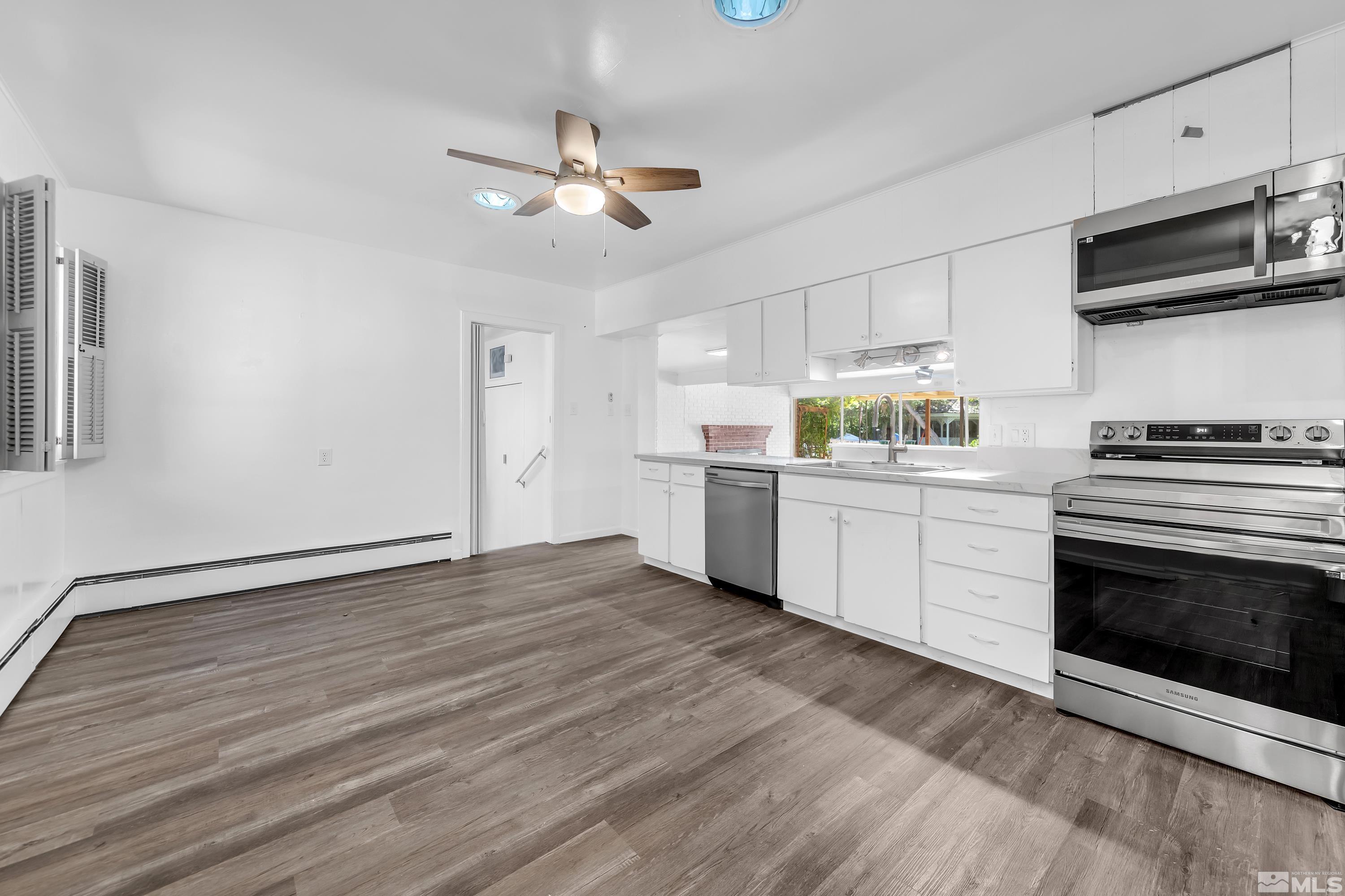 2199 Humboldt Street Reno, NV 89509 - Photo 6 of 35 a kitchen with stainless steel appliances a stove top oven a sink and cabinets