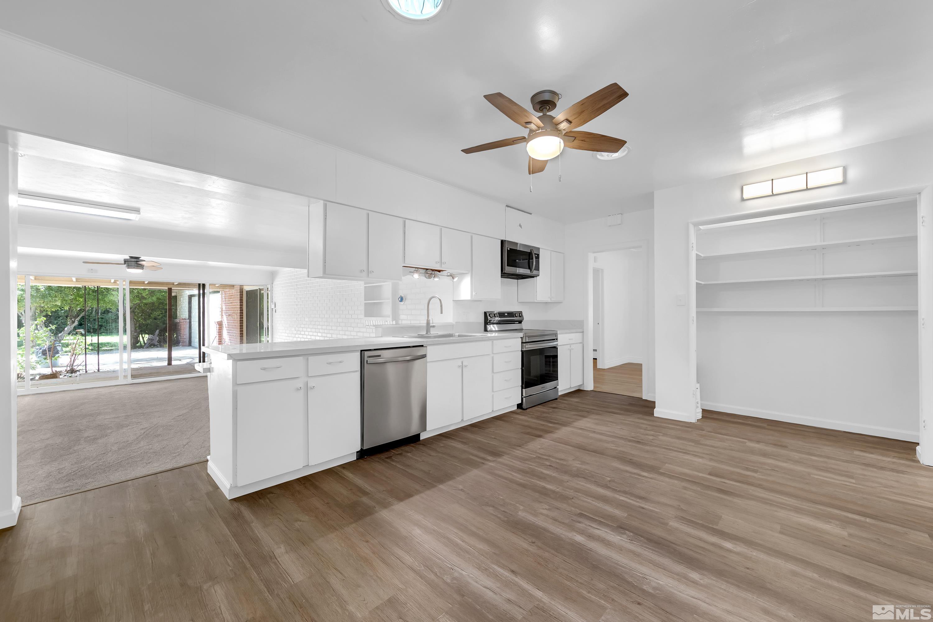 2199 Humboldt Street Reno, NV 89509 - Photo 7 of 35 a kitchen with a white cabinets and window