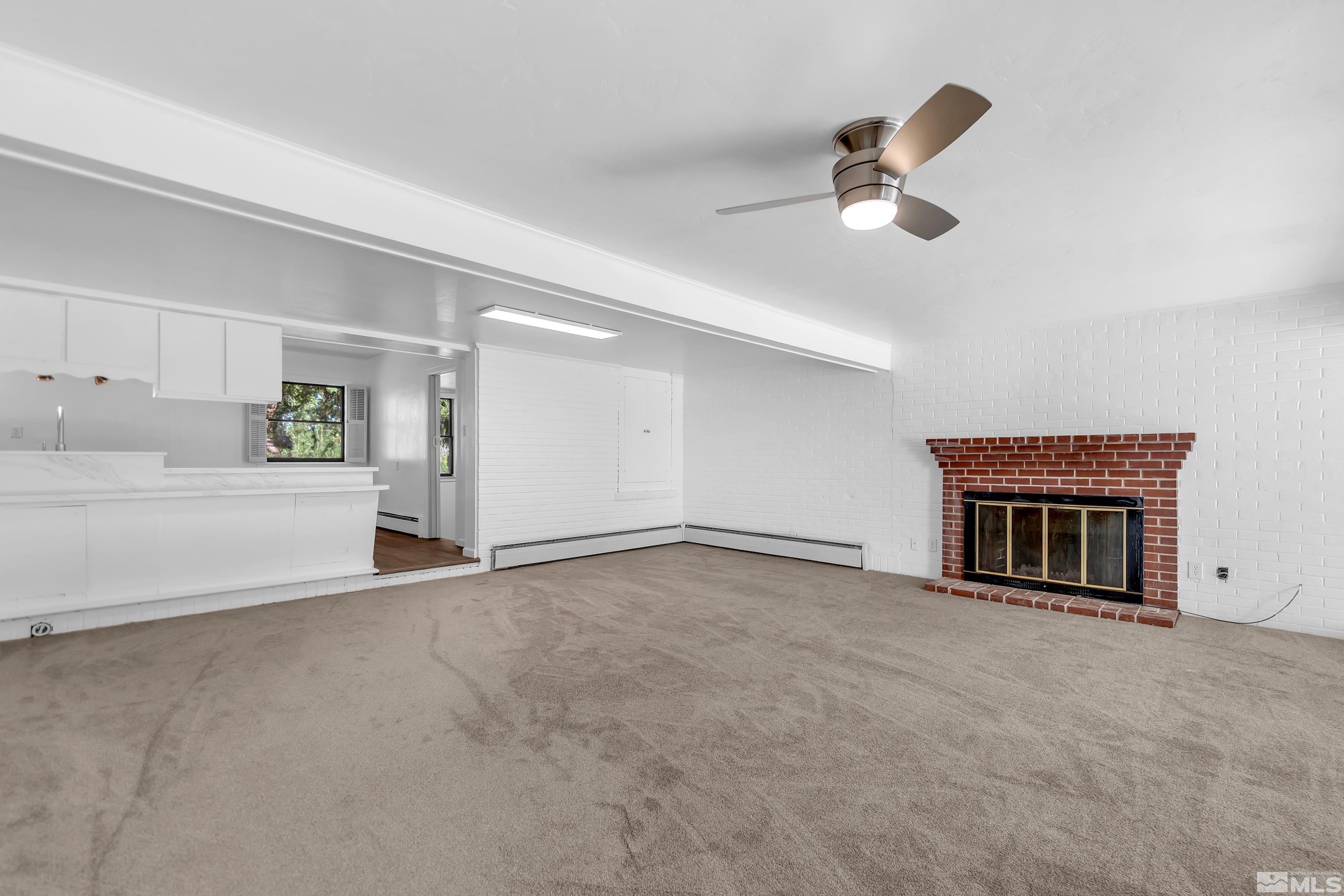 2199 Humboldt Street Reno, NV 89509 - Photo 9 of 35 a view of an empty room with a fireplace and a window