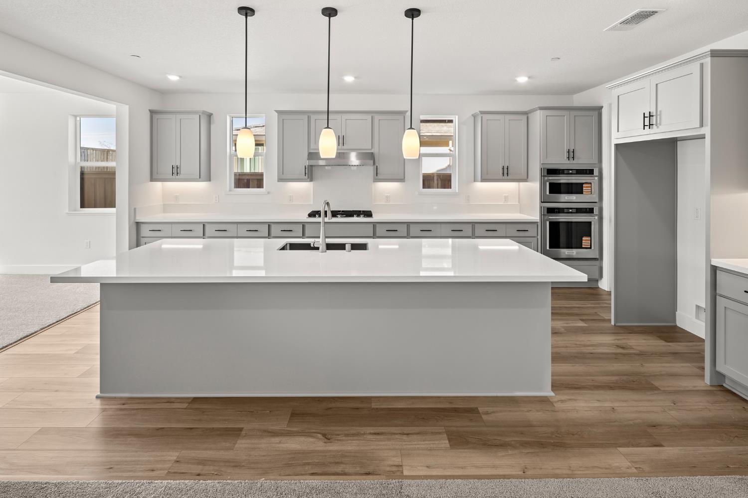2425 Briar Meadow Circle Auburn, CA 95603 - Photo 16 of 51 a large kitchen with kitchen island a large counter top stainless steel appliances and cabinets