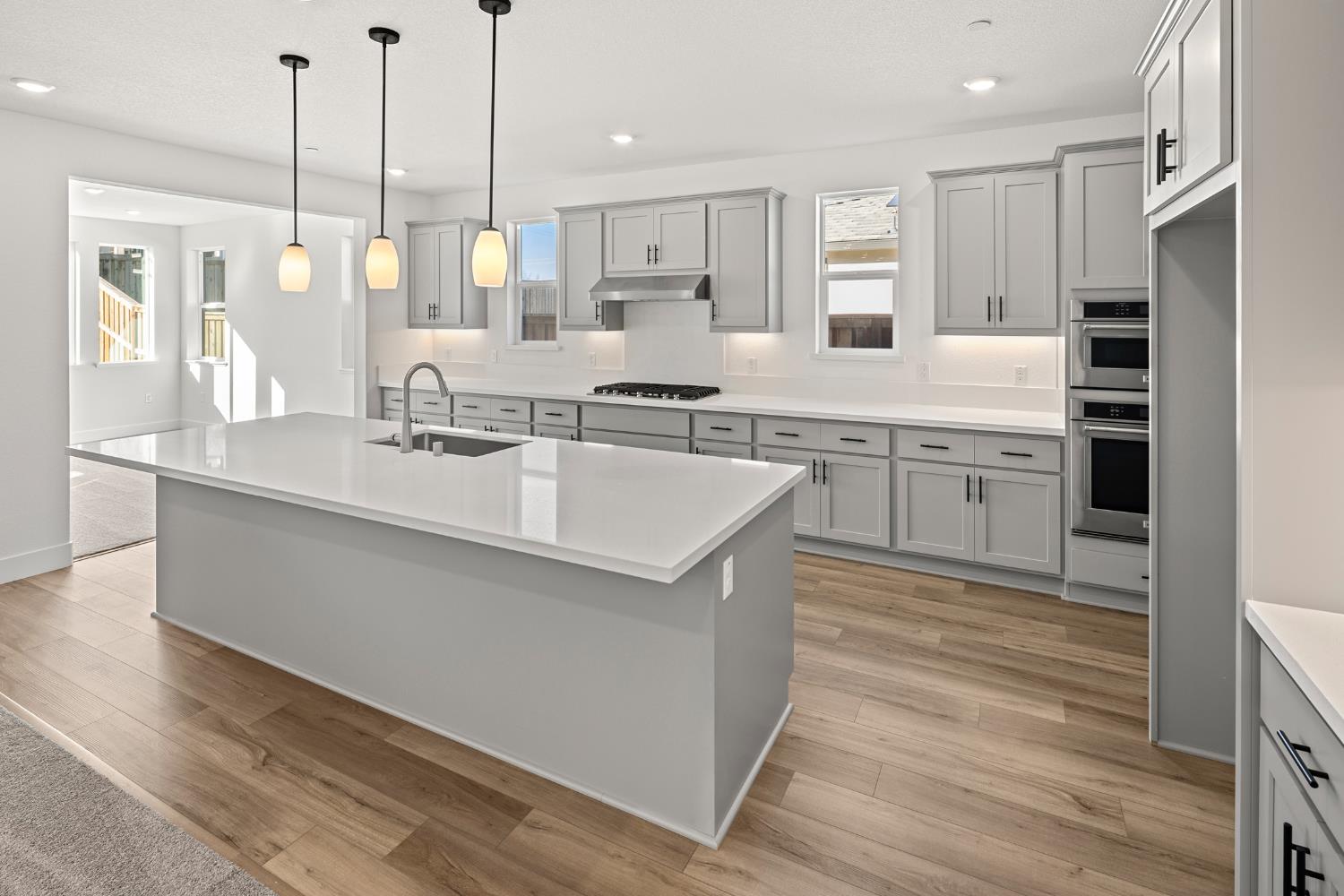 2425 Briar Meadow Circle Auburn, CA 95603 - Photo 4 of 51 a kitchen with stainless steel appliances granite countertop a sink a stove and a wooden floors