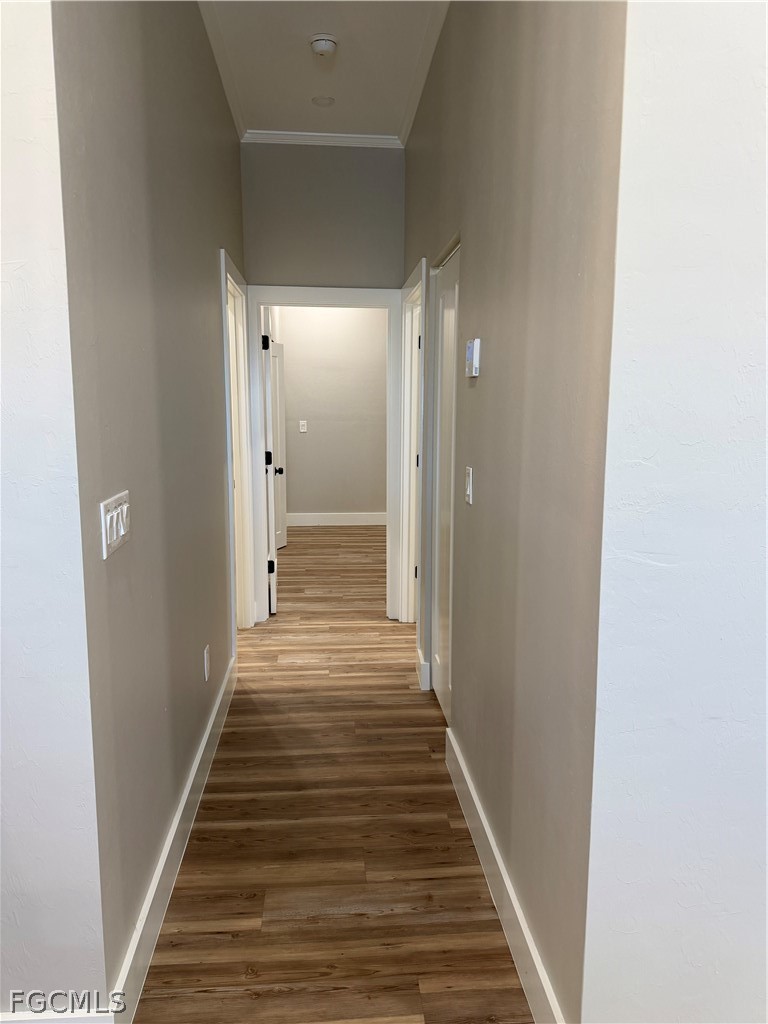 11595 Tomato Road Naples, FL 34114 - Photo 7 of 15 a view of a hallway with wooden floor