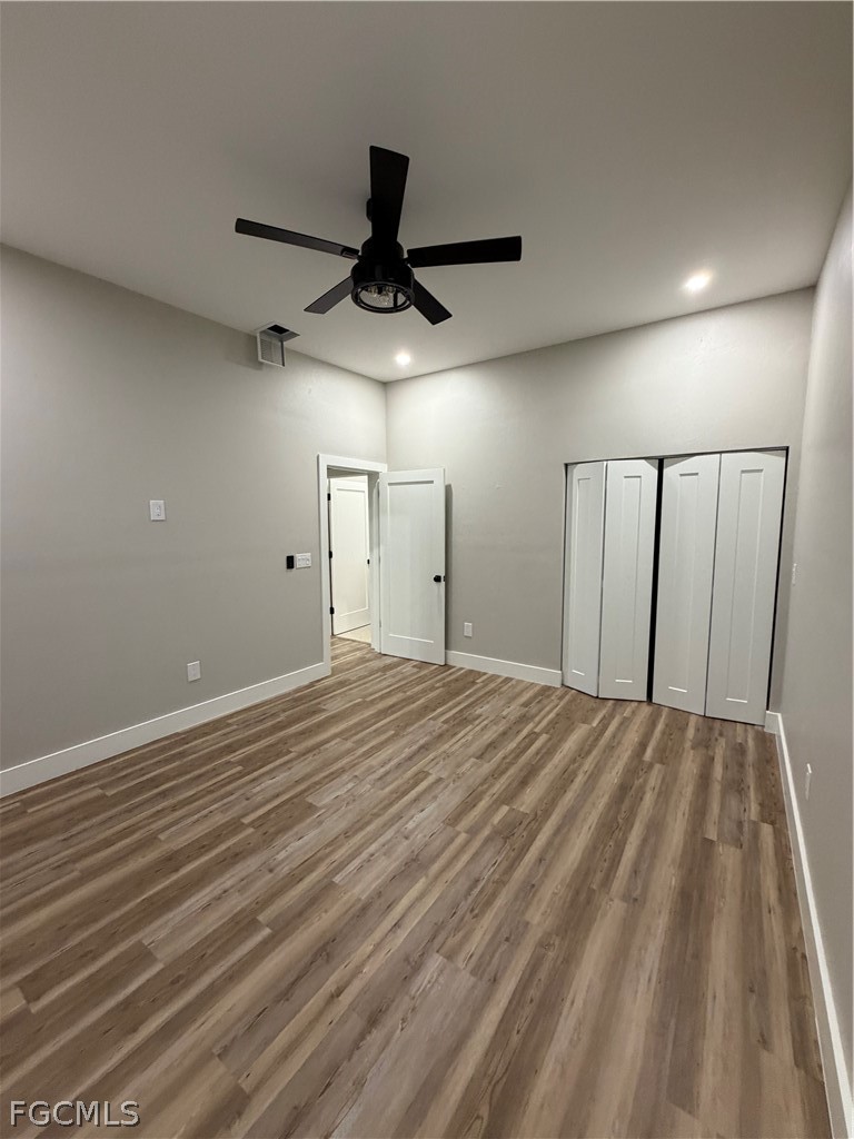 11595 Tomato Road Naples, FL 34114 - Photo 9 of 15 a view of empty room with wooden floor