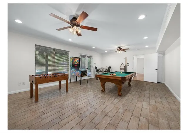 a living room with furniture a window and a ceiling fan