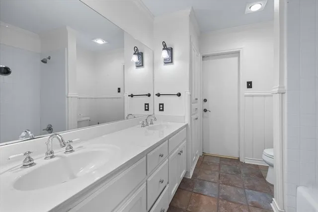 a spacious bathroom with a double vanity sink and mirror