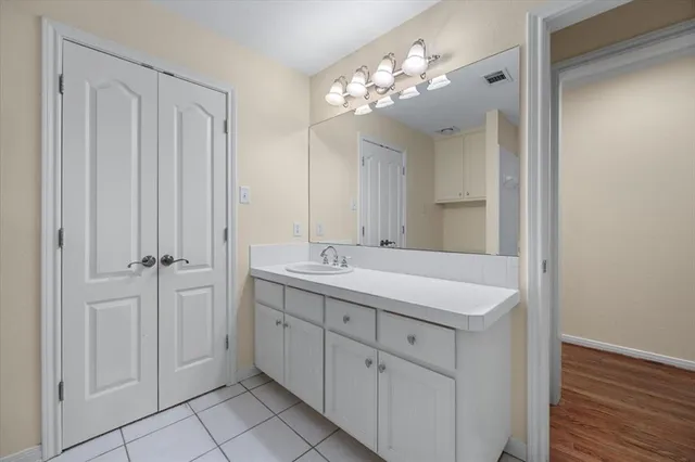 a bathroom with a double vanity sink and a mirror