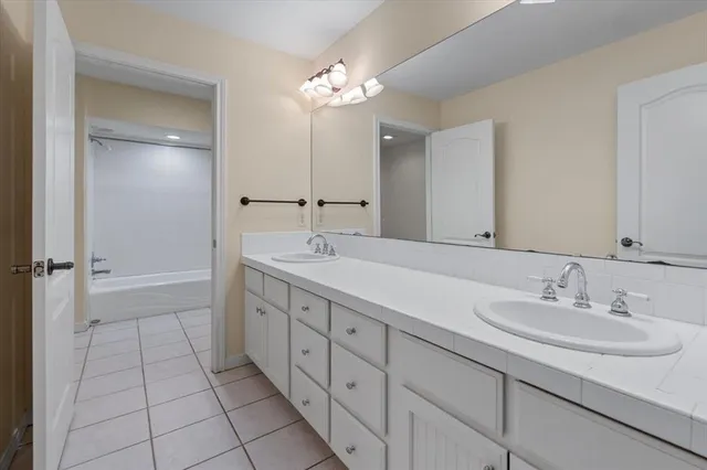 a bathroom with a double vanity sink and a mirror