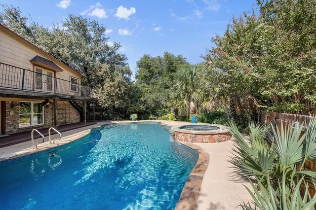 a view of yard with swimming pool and sitting area
