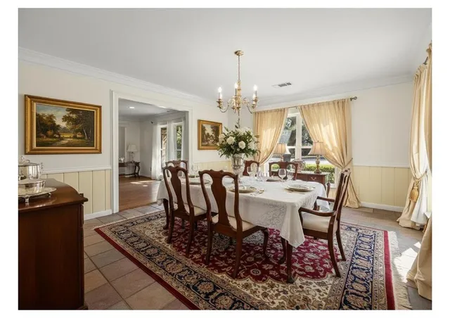 a view of a dining room with furniture and chandelier