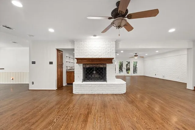 a living room with wooden floors and a fireplace