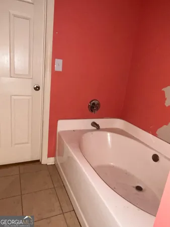 a bathroom with a tub and shower