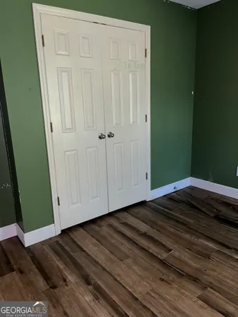 a view of a room with wooden floor