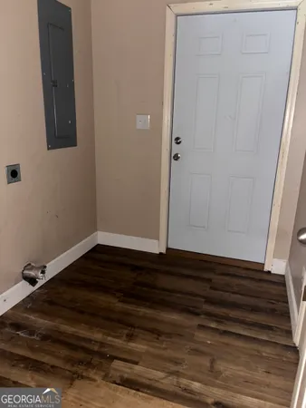 a view of room with wooden floor and cabinet