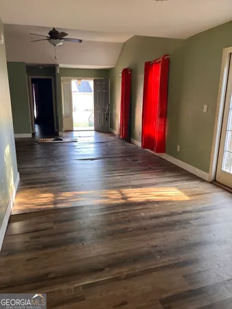 a view of a room with wooden floor and a window