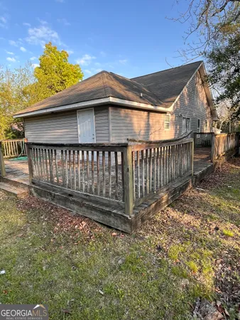 a view of a yard with wooden fence
