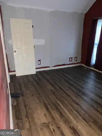 a view of an empty room and wooden floor