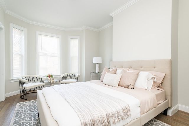 a bedroom with bed and a window