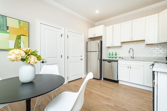 a view of kitchen with cabinets and wooden floor