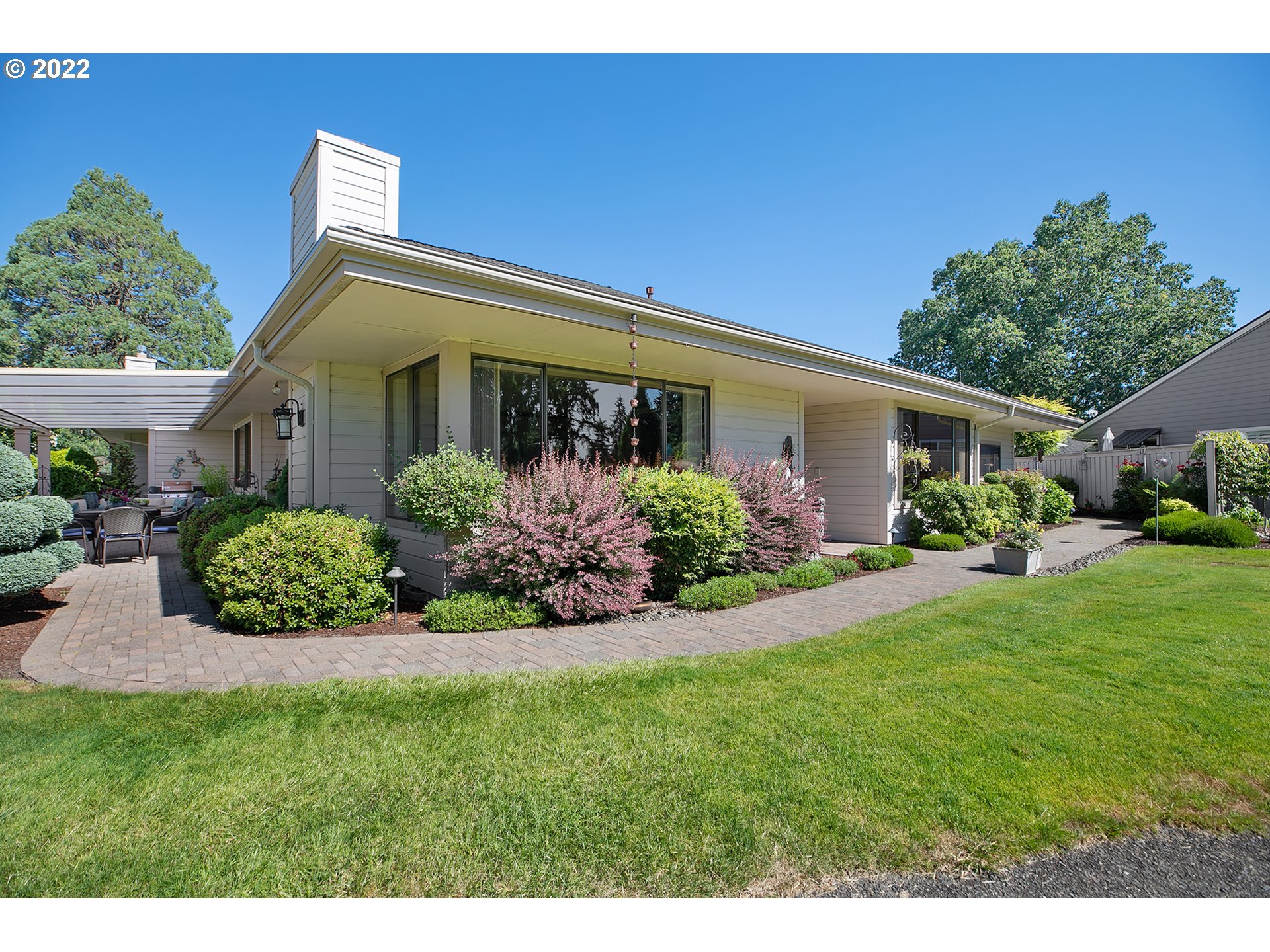 a front view of a house with a garden