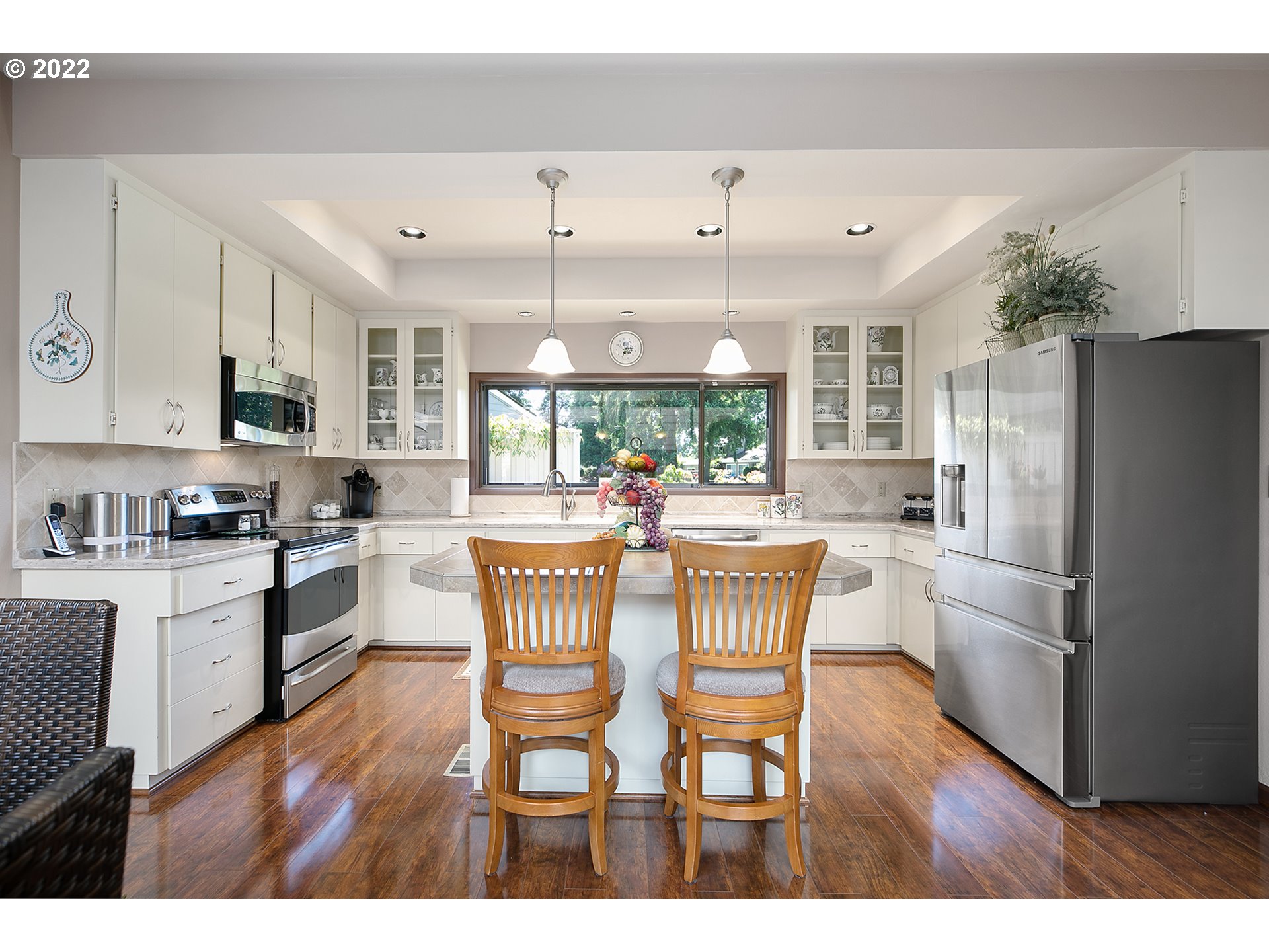 32221 Southwest Boones Bend Road Wilsonville, OR 97070 - Photo 15 of 32 a dining area with stainless steel appliances kitchen island granite countertop a dining table chairs and granite counter tops