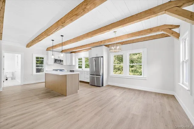 a bathroom with a granite countertop sink a toilet and a large mirror